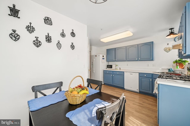 1402 Bonnett Pl Unit 131, Bel Air, MD 21015 - kitchen with white appliances, blue cabinets, light wood-style flooring, and light countertops