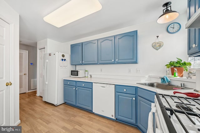 1402 Bonnett Pl Unit 131, Bel Air, MD 21015 - kitchen featuring white appliances, blue cabinetry, light wood finished floors, light countertops, and a sink