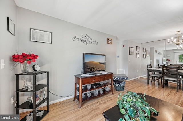 1402 Bonnett Pl Unit 131, Bel Air, MD 21015 - living area featuring light wood finished floors, a chandelier, and baseboards
