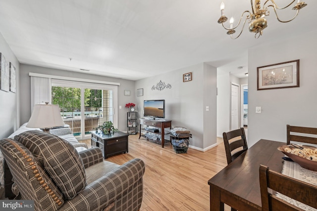 1402 Bonnett Pl Unit 131, Bel Air, MD 21015 - living room featuring a chandelier, light wood-style flooring, and baseboards