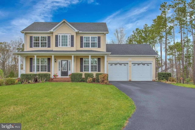 26635 Del Ibera Ct, Mechanicsville, MD 20659 - view of front of home with driveway, an attached garage, a front yard, and a porch