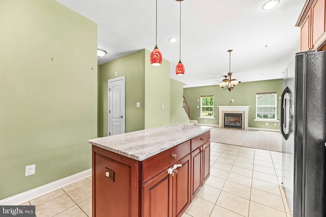 26635 Del Ibera Ct, Mechanicsville, MD 20659 - kitchen featuring freestanding refrigerator, light tile patterned flooring, ceiling fan, baseboards, and a fireplace