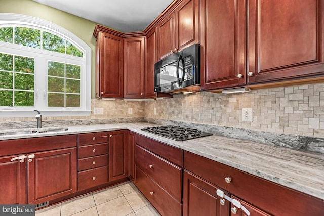26635 Del Ibera Ct, Mechanicsville, MD 20659 - kitchen featuring black appliances, a sink, tasteful backsplash, and light stone counters