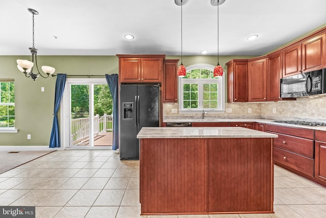 26635 Del Ibera Ct, Mechanicsville, MD 20659 - kitchen with black appliances, a kitchen island, a chandelier, tasteful backsplash, and recessed lighting