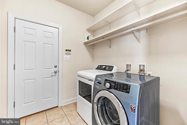 26635 Del Ibera Ct, Mechanicsville, MD 20659 - washroom featuring washing machine and dryer, light tile patterned floors, and baseboards