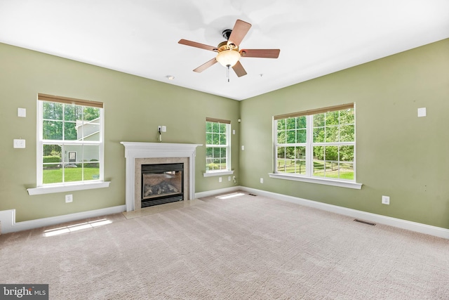 26635 Del Ibera Ct, Mechanicsville, MD 20659 - unfurnished living room with plenty of natural light, a fireplace, baseboards, and a ceiling fan
