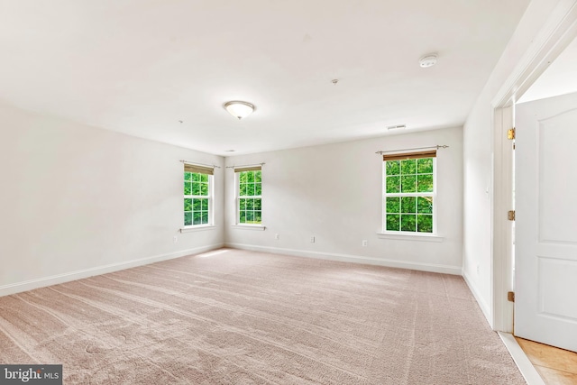 26635 Del Ibera Ct, Mechanicsville, MD 20659 - unfurnished room with healthy amount of natural light, light colored carpet, baseboards, and a smoke detector