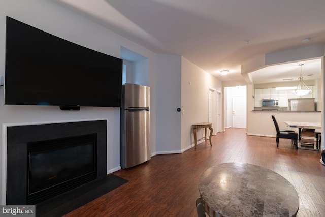 4320 Cannon Ridge Ct Unit 50, Fairfax, VA 22030 - living room featuring dark wood-type flooring, baseboards, and a fireplace with flush hearth