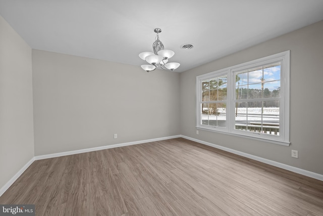21830 Vaughn Rd, Georgetown, DE 19947 - spare room with a chandelier, wood finished floors, and baseboards
