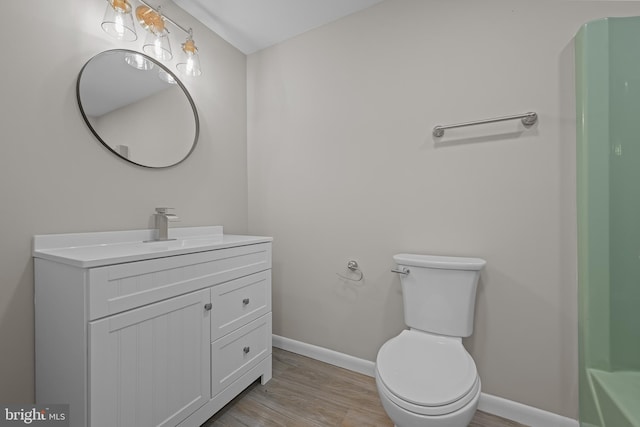 21830 Vaughn Rd, Georgetown, DE 19947 - bathroom with wood finished floors, baseboards, vanity, and toilet