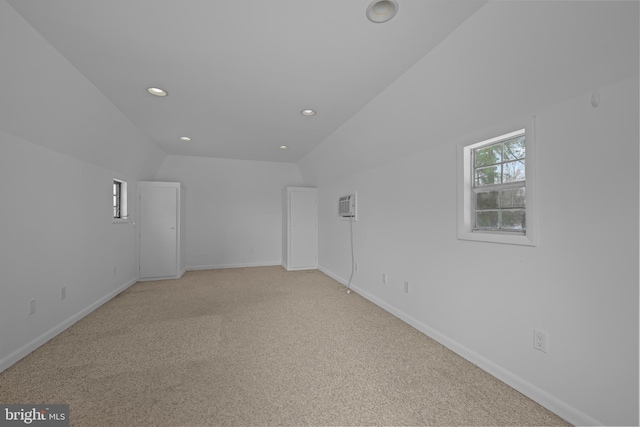 21830 Vaughn Rd, Georgetown, DE 19947 - empty room with recessed lighting, baseboards, light carpet, an AC wall unit, and vaulted ceiling