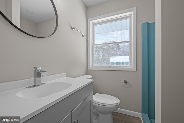 21830 Vaughn Rd, Georgetown, DE 19947 - bathroom with toilet, vanity, wood finished floors, and baseboards