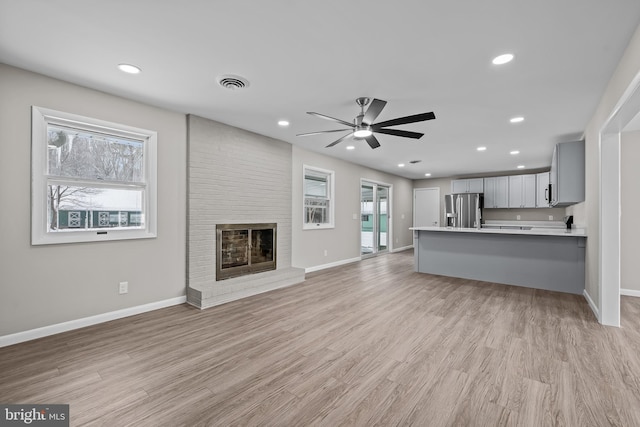 21830 Vaughn Rd, Georgetown, DE 19947 - unfurnished living room with a ceiling fan, baseboards, light wood finished floors, recessed lighting, and a fireplace