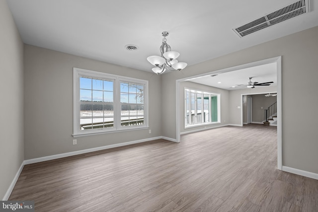 21830 Vaughn Rd, Georgetown, DE 19947 - unfurnished room with healthy amount of natural light, stairs, a chandelier, and baseboards