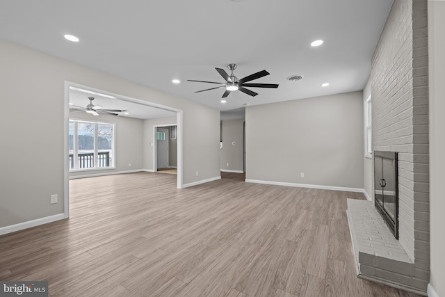 21830 Vaughn Rd, Georgetown, DE 19947 - unfurnished living room featuring a brick fireplace, a ceiling fan, light wood-type flooring, baseboards, and recessed lighting