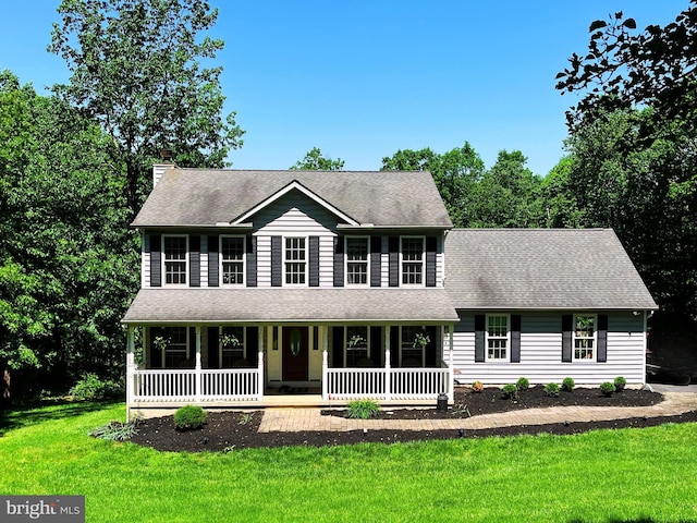 123 Talton Dr, Delta, PA 17314 - colonial-style house featuring covered porch, a front yard, a chimney, and a shingled roof