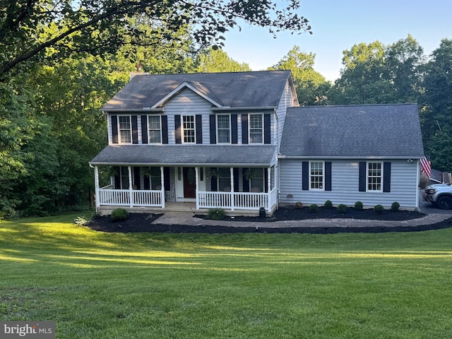 123 Talton Dr, Delta, PA 17314 - colonial-style house featuring a porch, a front yard, and roof with shingles