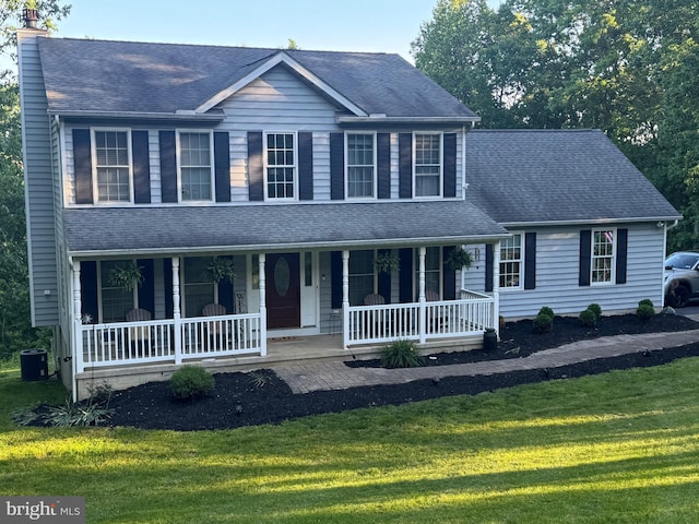123 Talton Dr, Delta, PA 17314 - view of front of house with covered porch, a front yard, central AC, and a chimney