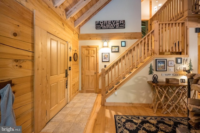 532 Pine Grove Rd, Lonaconing, MD 21539 - entryway featuring beamed ceiling, stairway, high vaulted ceiling, light wood finished floors, and wooden walls