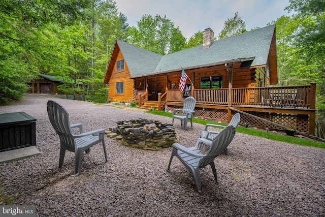 532 Pine Grove Rd, Lonaconing, MD 21539 - back of house with log siding, a fire pit, a shingled roof, and a chimney