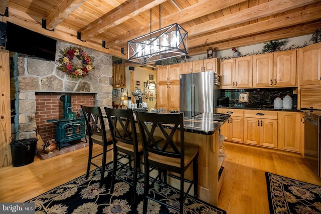 532 Pine Grove Rd, Lonaconing, MD 21539 - kitchen featuring high end refrigerator, wooden ceiling with exposed beams, light wood-style floors, a wood stove, and a kitchen breakfast bar