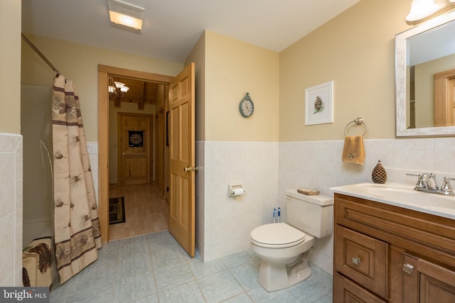 532 Pine Grove Rd, Lonaconing, MD 21539 - full bathroom with tile walls, toilet, a wainscoted wall, vanity, and tile patterned floors
