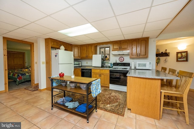 532 Pine Grove Rd, Lonaconing, MD 21539 - kitchen with white appliances, under cabinet range hood, brown cabinets, a drop ceiling, and light tile patterned floors