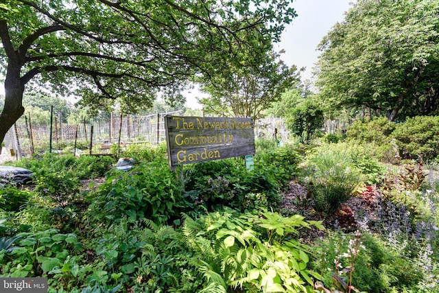community / neighborhood sign featuring fence