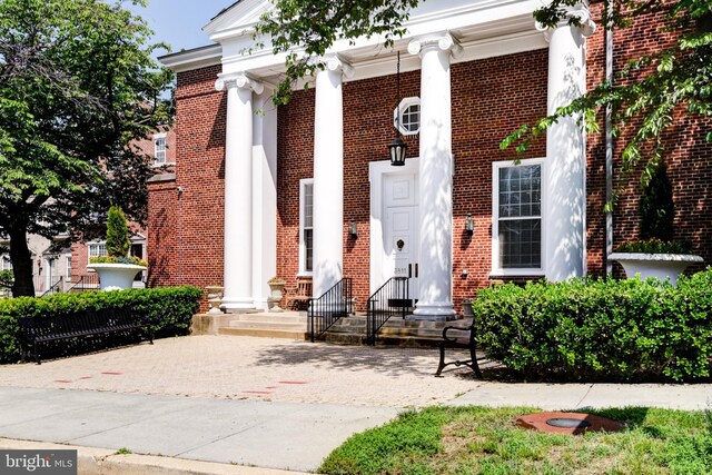 property entrance with brick siding