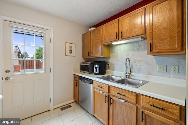 104 Braeburn Dr, Winchester, VA 22601 - kitchen with stainless steel appliances, a sink, light countertops, backsplash, and light tile patterned flooring