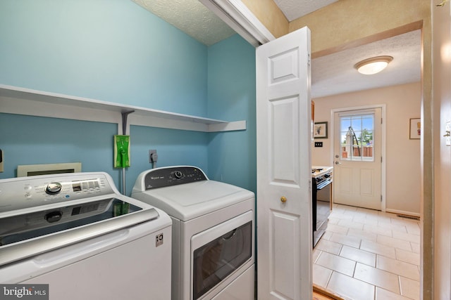 104 Braeburn Dr, Winchester, VA 22601 - washroom with washer and clothes dryer, a textured ceiling, light tile patterned flooring, and baseboards
