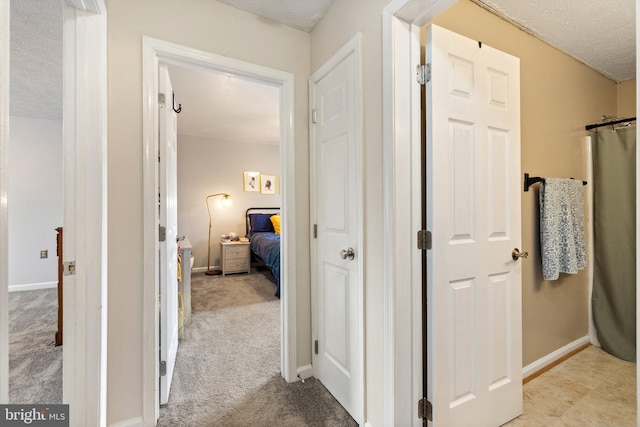 104 Braeburn Dr, Winchester, VA 22601 - hallway with a textured ceiling, light carpet, and baseboards