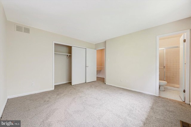 unfurnished bedroom with carpet floors, a closet, and baseboards