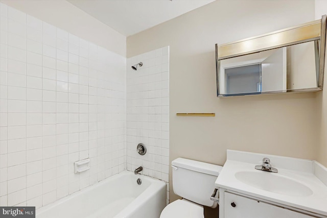 full bath featuring toilet, vanity, and  shower combination