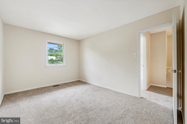 empty room with carpet and baseboards
