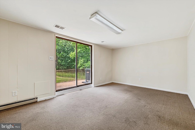 empty room featuring carpet flooring, baseboard heating, and baseboards