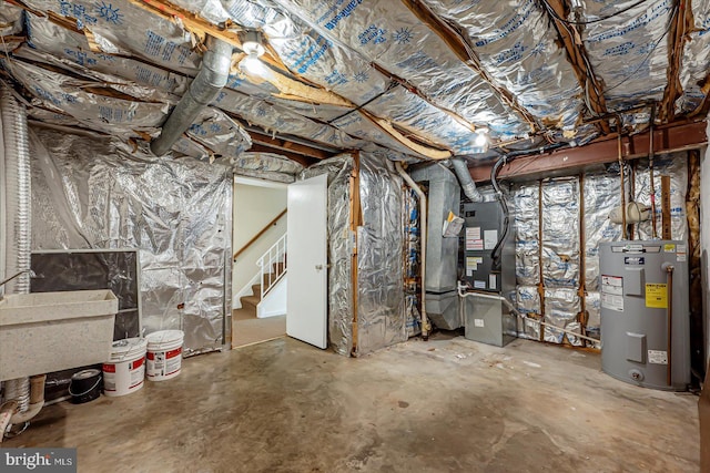 unfinished below grade area featuring water heater, stairs, heating unit, and a sink