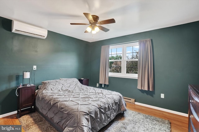 3308 Glen Hollow Dr Unit 103B, Dover, PA 17315 - bedroom with a wall mounted AC, a baseboard heating unit, wood finished floors, baseboards, and ceiling fan