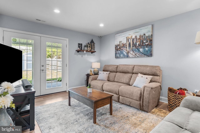 living room featuring wood finished floors, french doors, recessed lighting, and baseboards