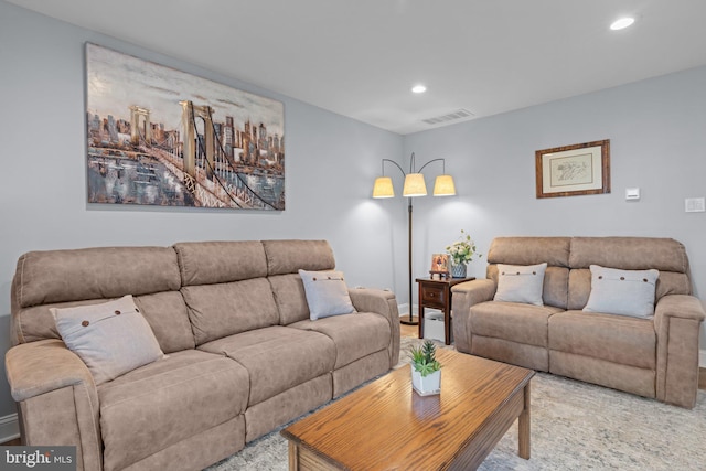living room featuring recessed lighting and baseboards