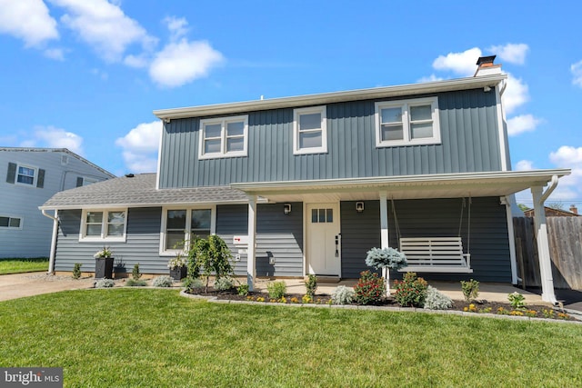 traditional home with a porch, board and batten siding, and a chimney