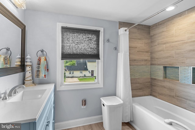 full bathroom with shower / bath combo with shower curtain, vanity, wood finished floors, recessed lighting, and baseboards