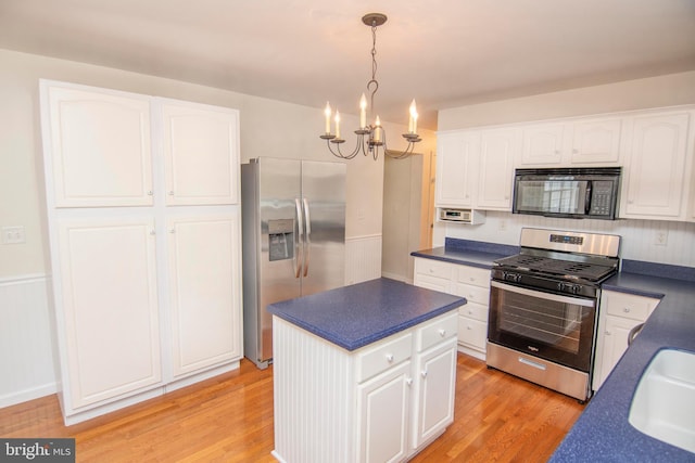 3516 Prospect Road, St, MD 21154 - kitchen featuring appliances with stainless steel finishes, dark countertops, a chandelier, and white cabinets