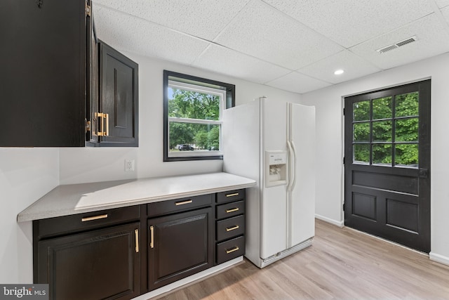 39743 Daniel Cir, Mechanicsville, MD 20659 - kitchen featuring white fridge with ice dispenser, light wood-style floors, light countertops, a paneled ceiling, and baseboards