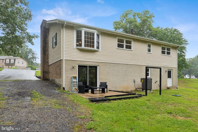 39743 Daniel Cir, Mechanicsville, MD 20659 - rear view of house with a yard, central AC, and gravel driveway