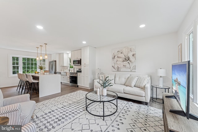 39743 Daniel Cir, Mechanicsville, MD 20659 - living room with wood finished floors, recessed lighting, and a chandelier