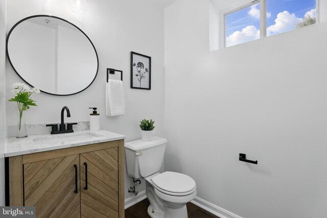 6019 Surrey Square Ln, District Heights, MD 20747 - bathroom featuring toilet, vanity, baseboards, and wood finished floors