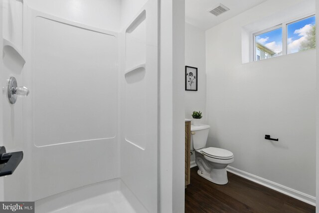 6019 Surrey Square Ln, District Heights, MD 20747 - full bathroom featuring baseboards, wood finished floors, toilet, and a shower