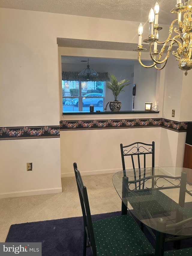 dining room featuring a chandelier and carpet floors