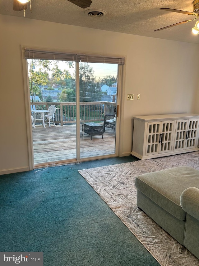 bedroom with carpet, access to exterior, a textured ceiling, and ceiling fan